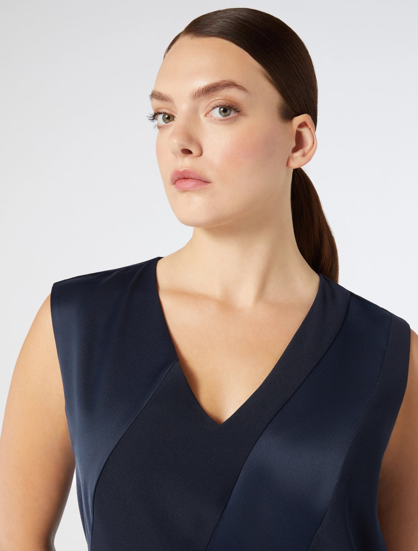 "Close up of V-neck and satin panels on CLORURO dress"