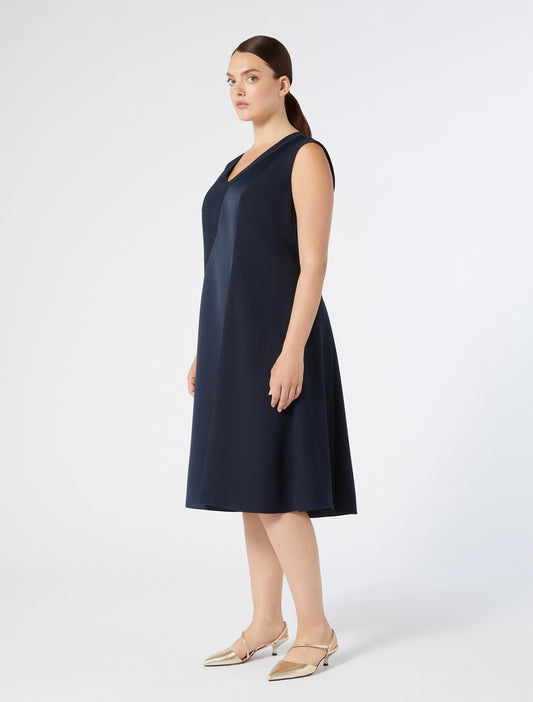 "Model in navy blue CLORURO dress with flared hem"
