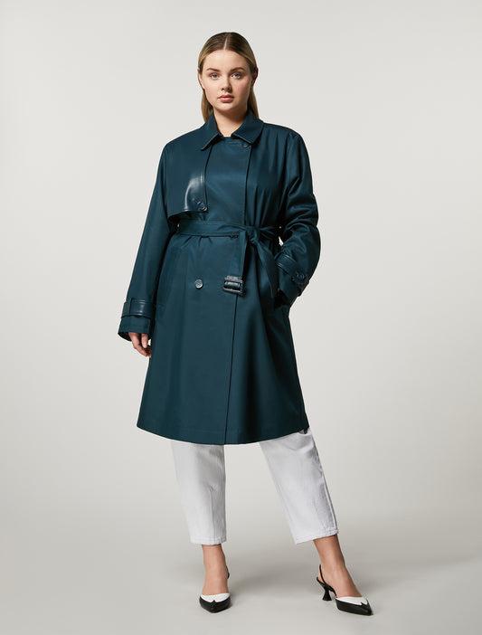 Crafted from water-resistant cotton with coated jersey details, the double-breasted trench coat features a lapel collar, belted waist and hook-and-eye closure for a sophisticated