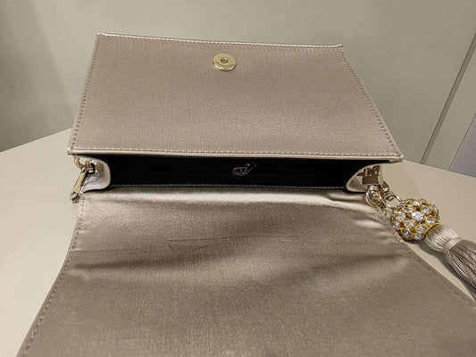 Elegant pearl satin leather bag with rhinestone tassel and gold chain strap by Marina Rinaldi