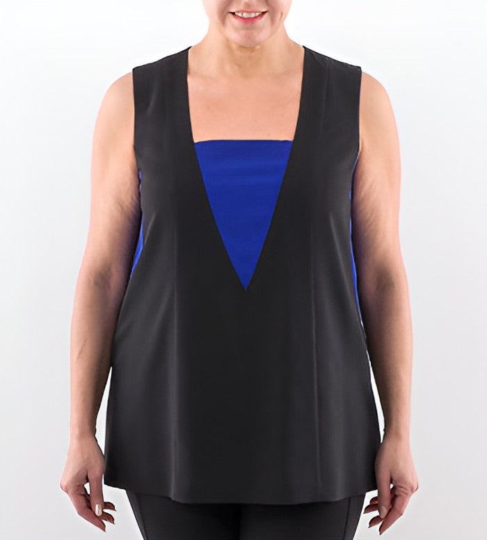 A woman wearing a sleeveless black tunic top with a bold royal blue geometric color-block design on the chest, set against a plain white studio background.