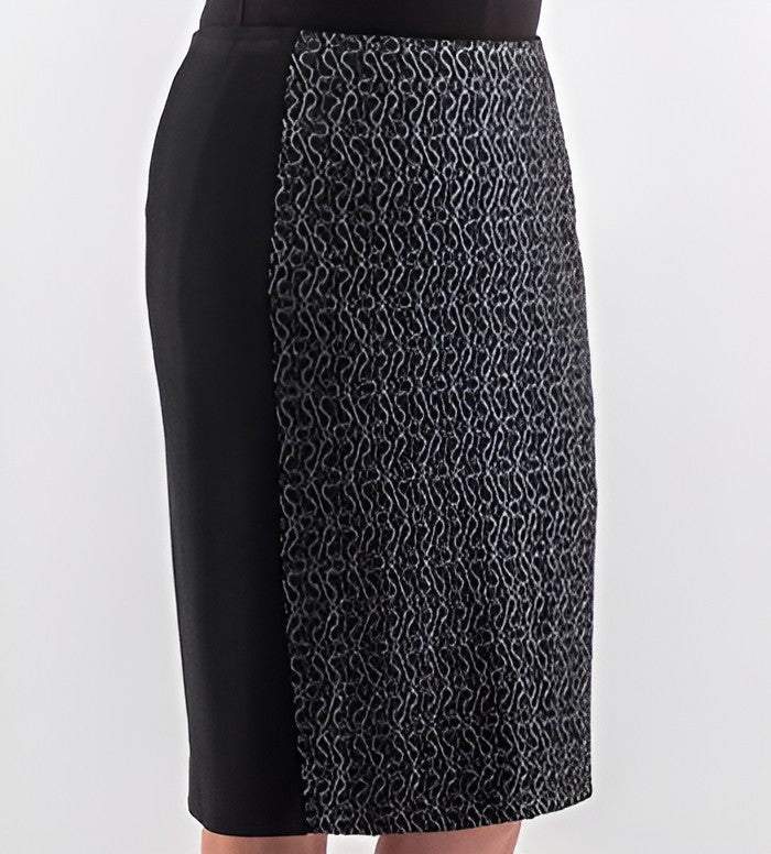A black knee-length skirt with a textured, patterned panel on the front right side, shown on a model against a light gray background.