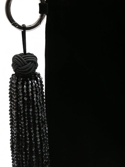 Close-up of black beaded tassel on SAHARA velvet clutch
