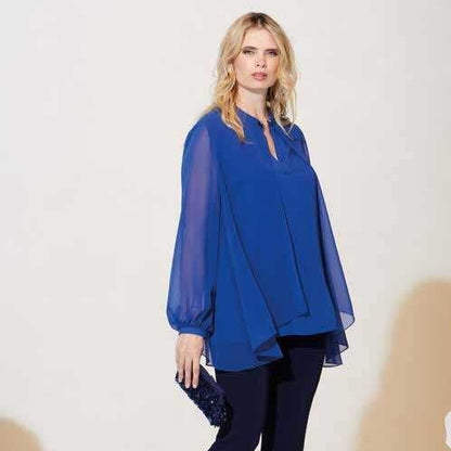 This amazing blue chiffon blouse has a flowing yoke, long sleeves, and a tear-shaped collar