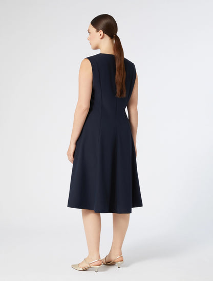 "Back view of CLORURO dress showing fitted top and flowy skirt"
