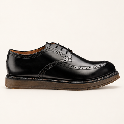 Marina Rinaldi LAURO Leather Oxford shoe in black leather, with lace-up fastening, perforated brogue trim and chunky brown sole.
