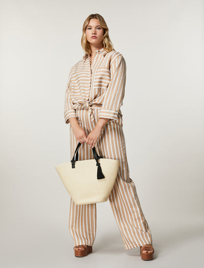 Model wearing full striped set with ALABAMA blouse tied at waist and CRISMA trousers