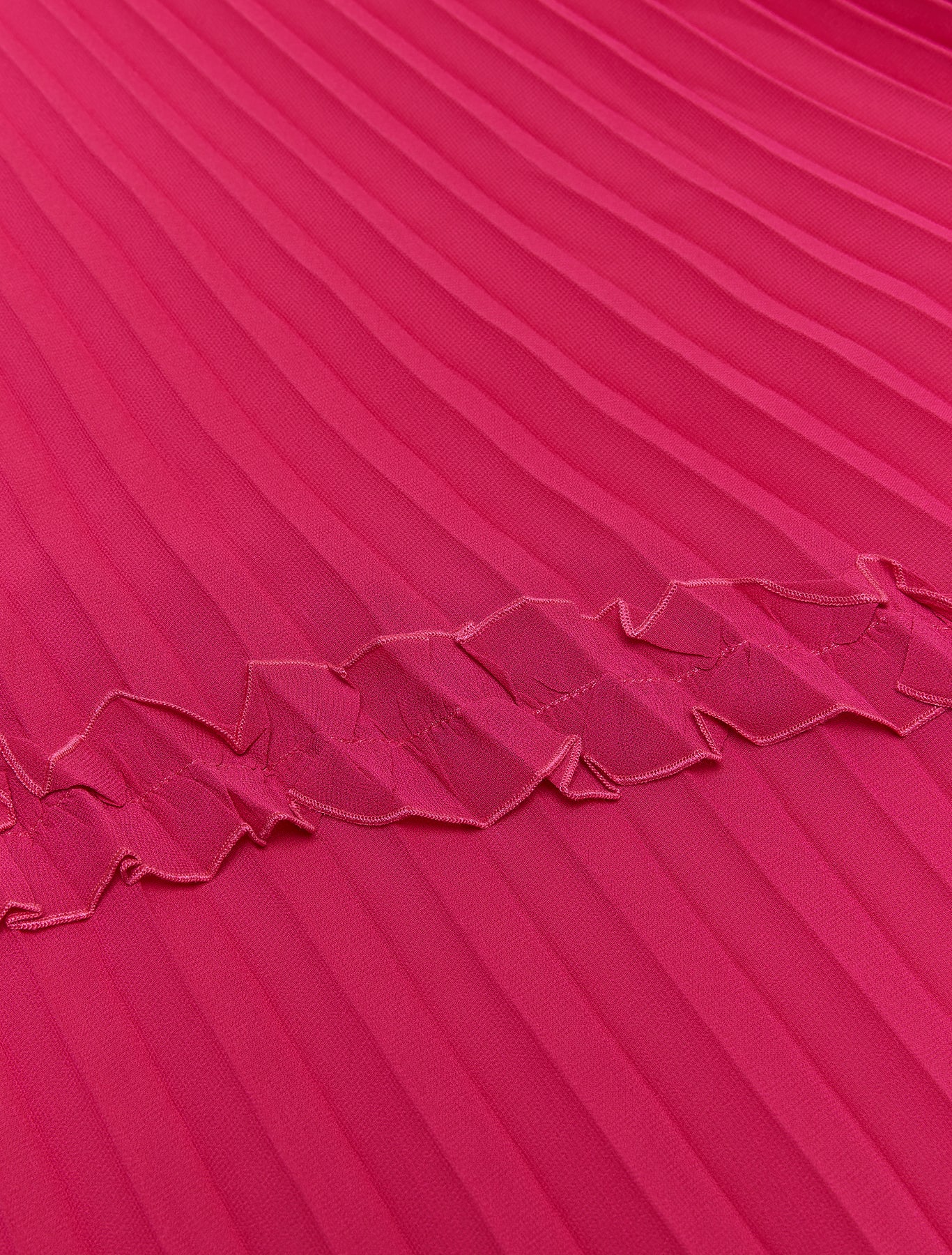 Close-up of pleated detail and stitched trims on pink stole”

