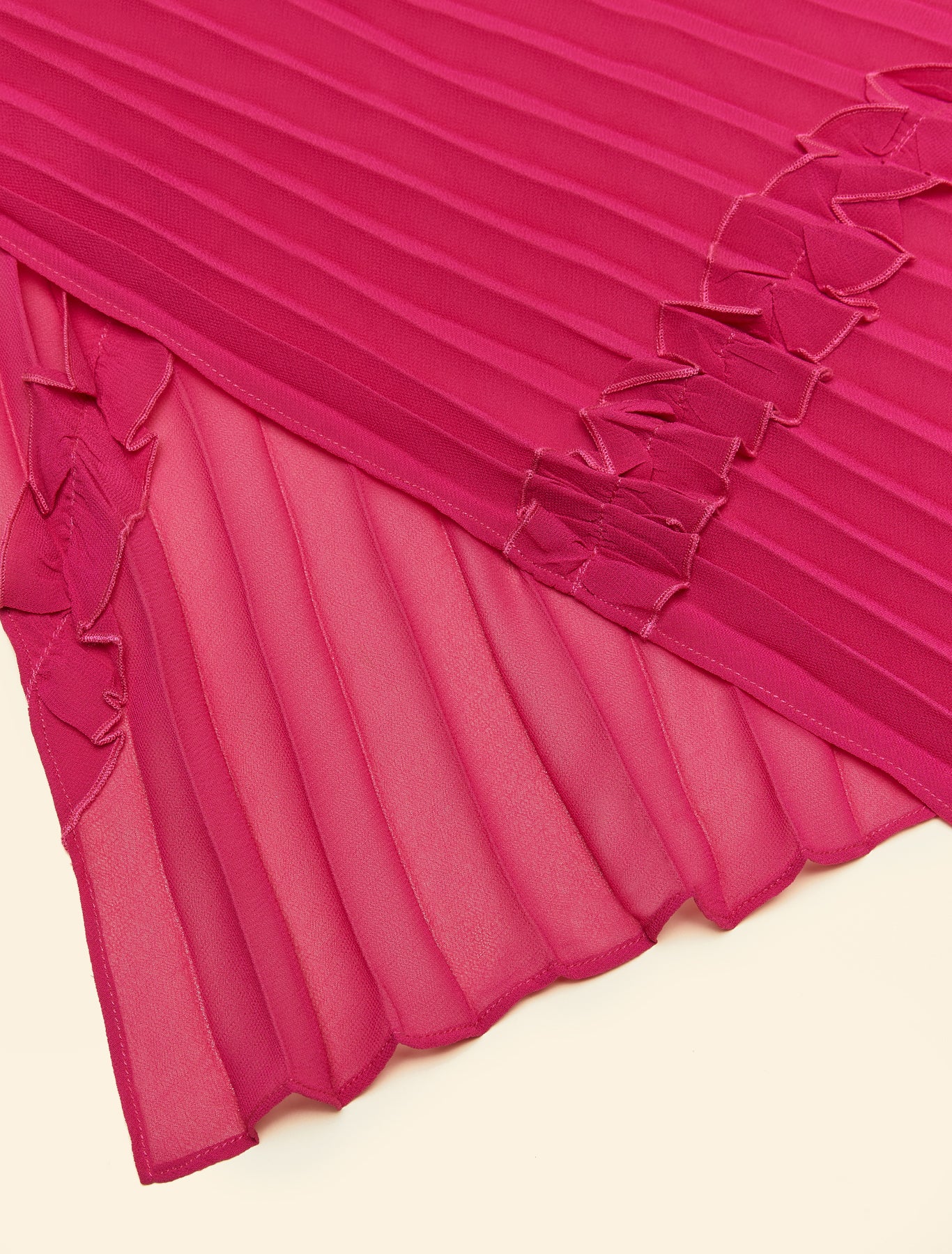 “Edge of pink stole showing delicate ruffle pleats”