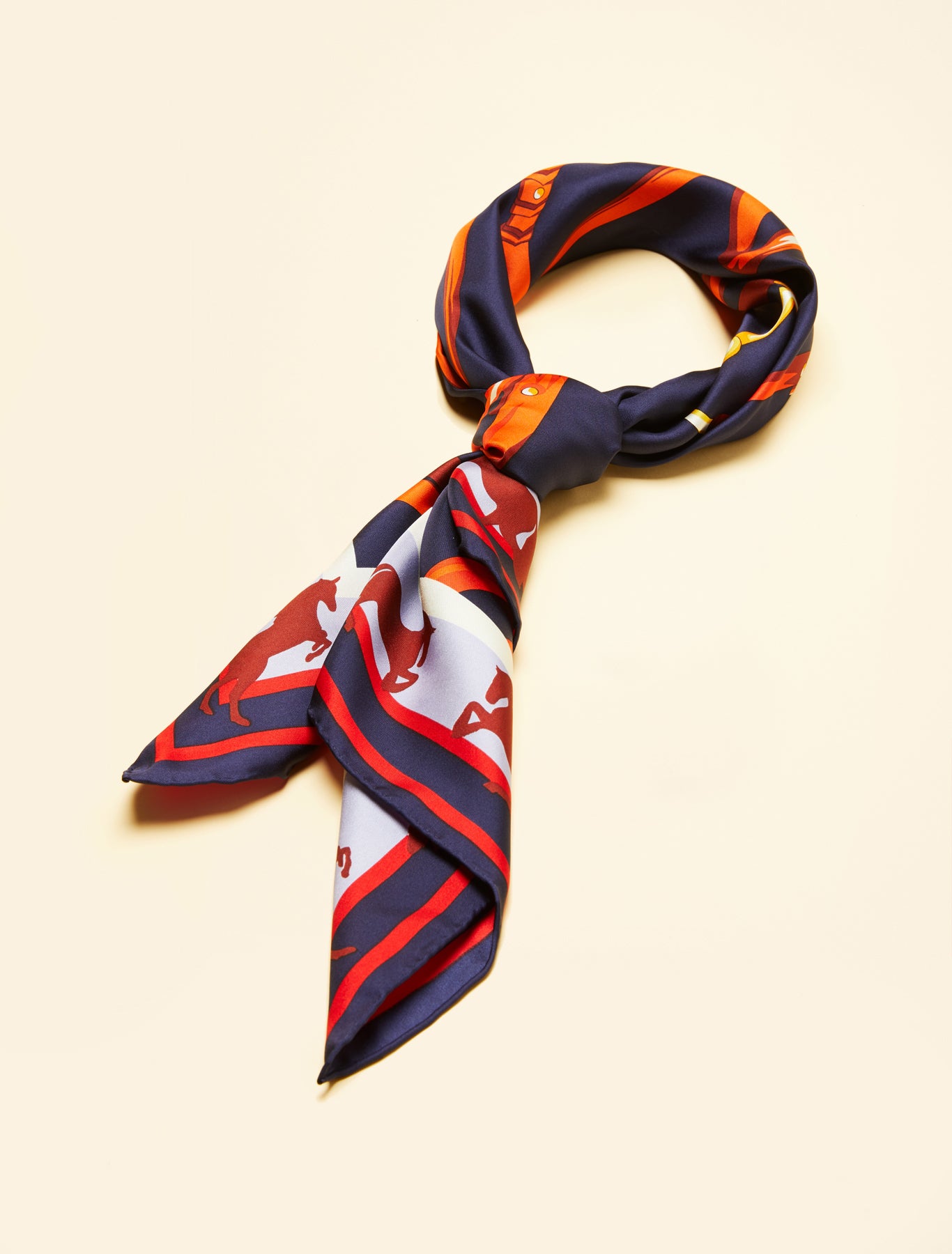 “SAGGISTA silk neckerchief tied in a knot with equestrian print”