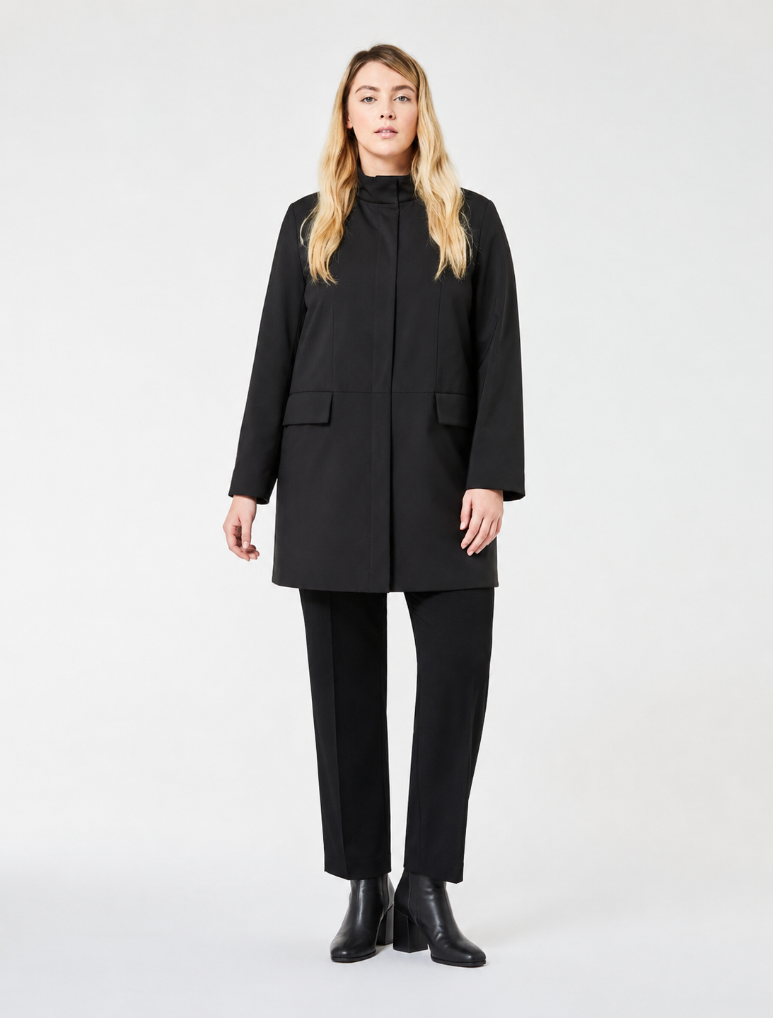 Woman wearing NESSO quilted coat with stand-up collar and flap pockets in urban setting