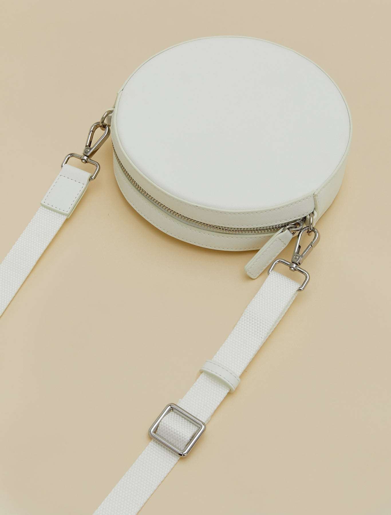 Covered fabric round bag with adjustable grosgrain strap and zipper closure