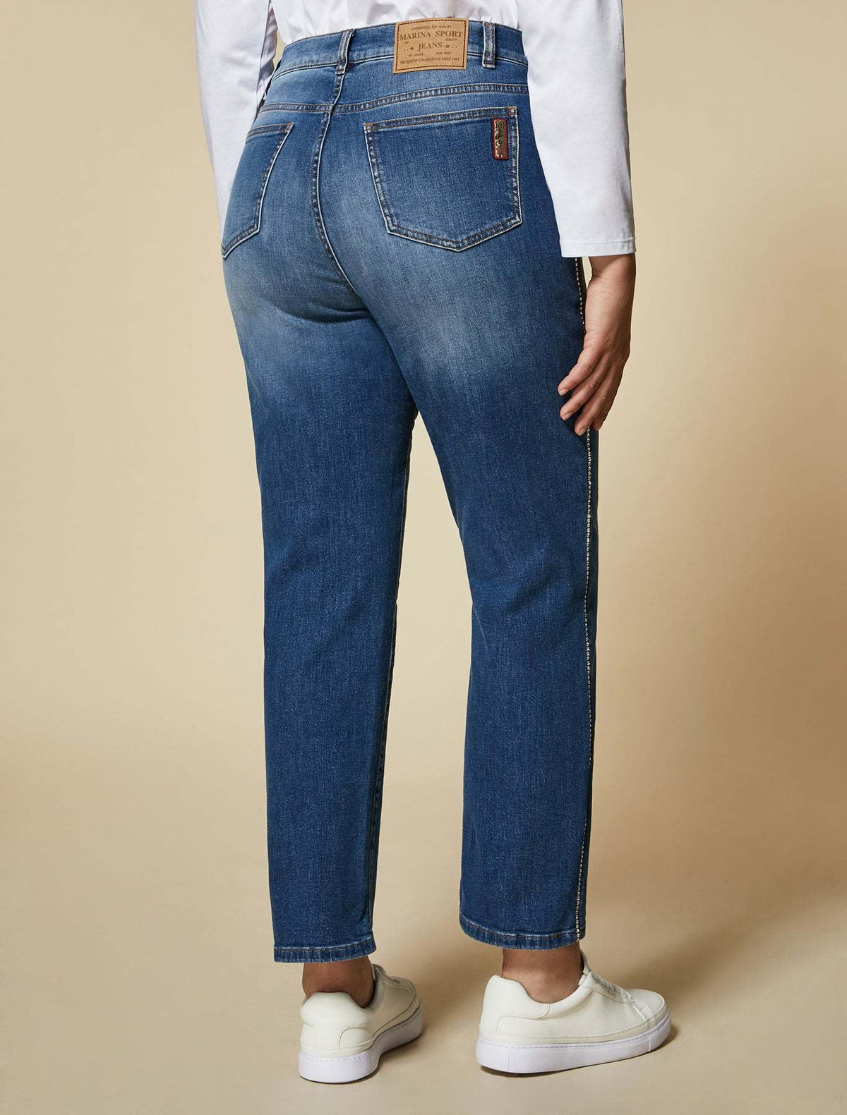 IDEALE jeans in medium blue stretch denim featuring crystal rhinestone stripes along side seams and a classic mid-rise fit.