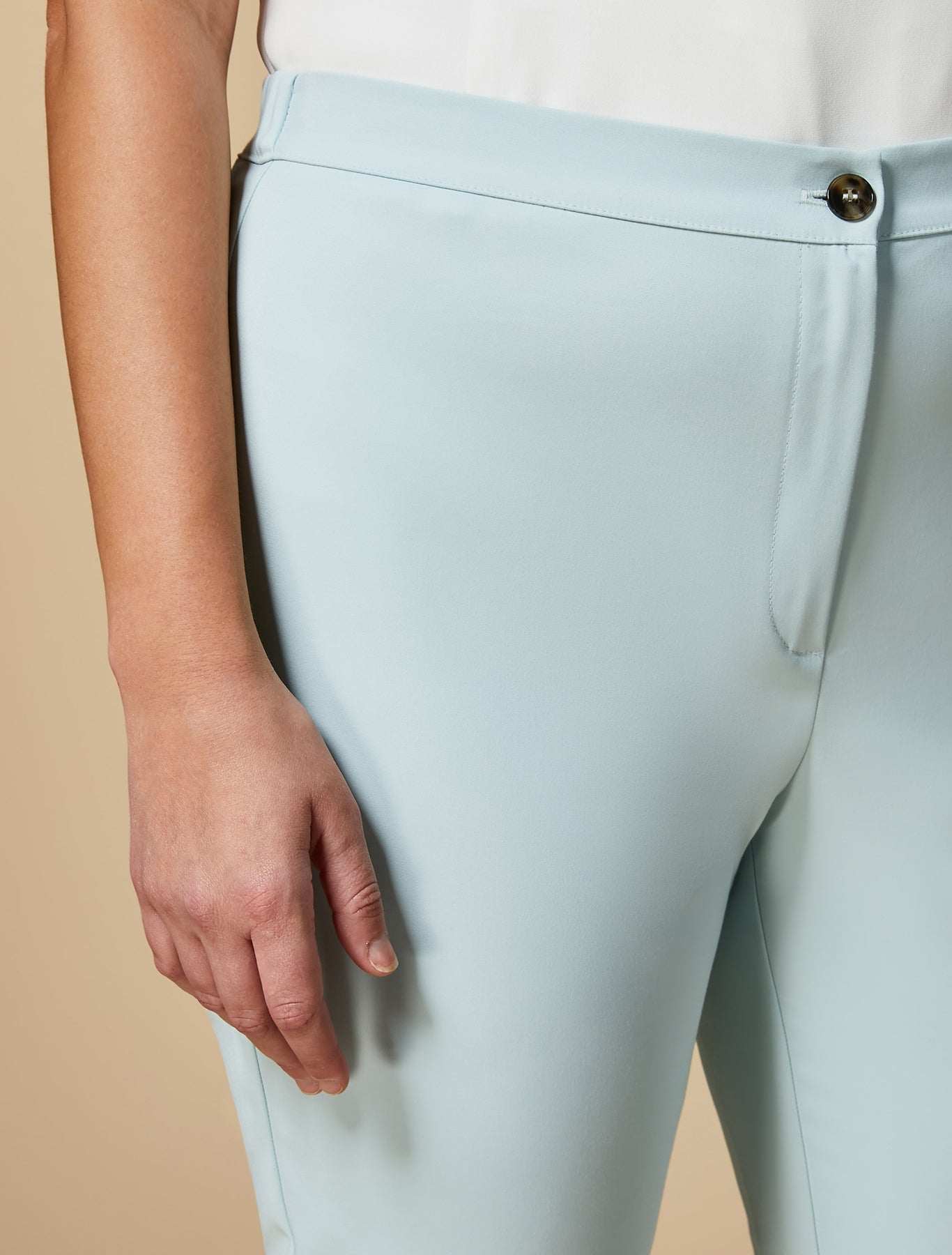 Thin trousers made of elastic cotton and nylon with elastic waist insert and hidden button