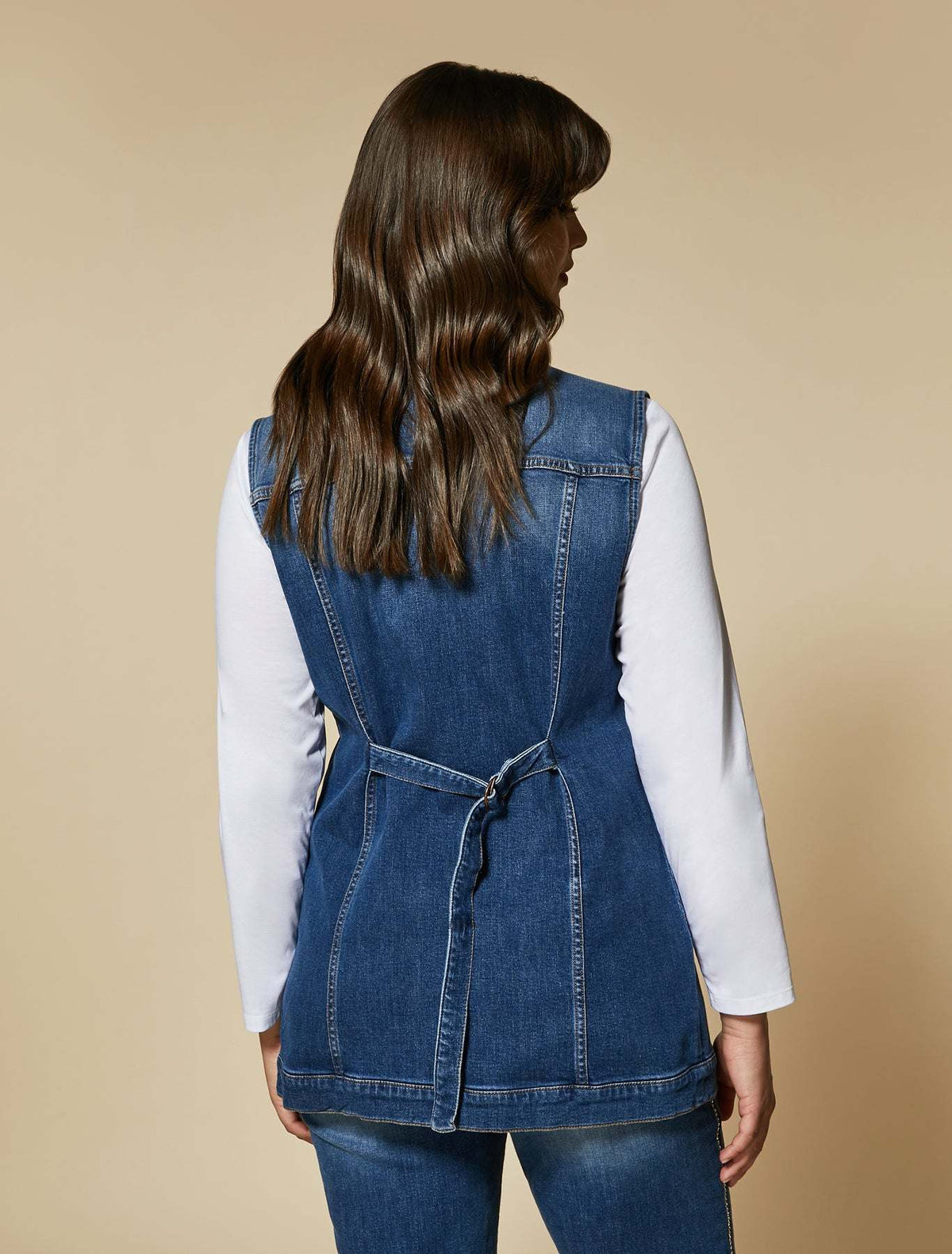 GABBIATE denim vest in blue stretch cotton with back buckle strap and vertical seams for a fitted silhouette.