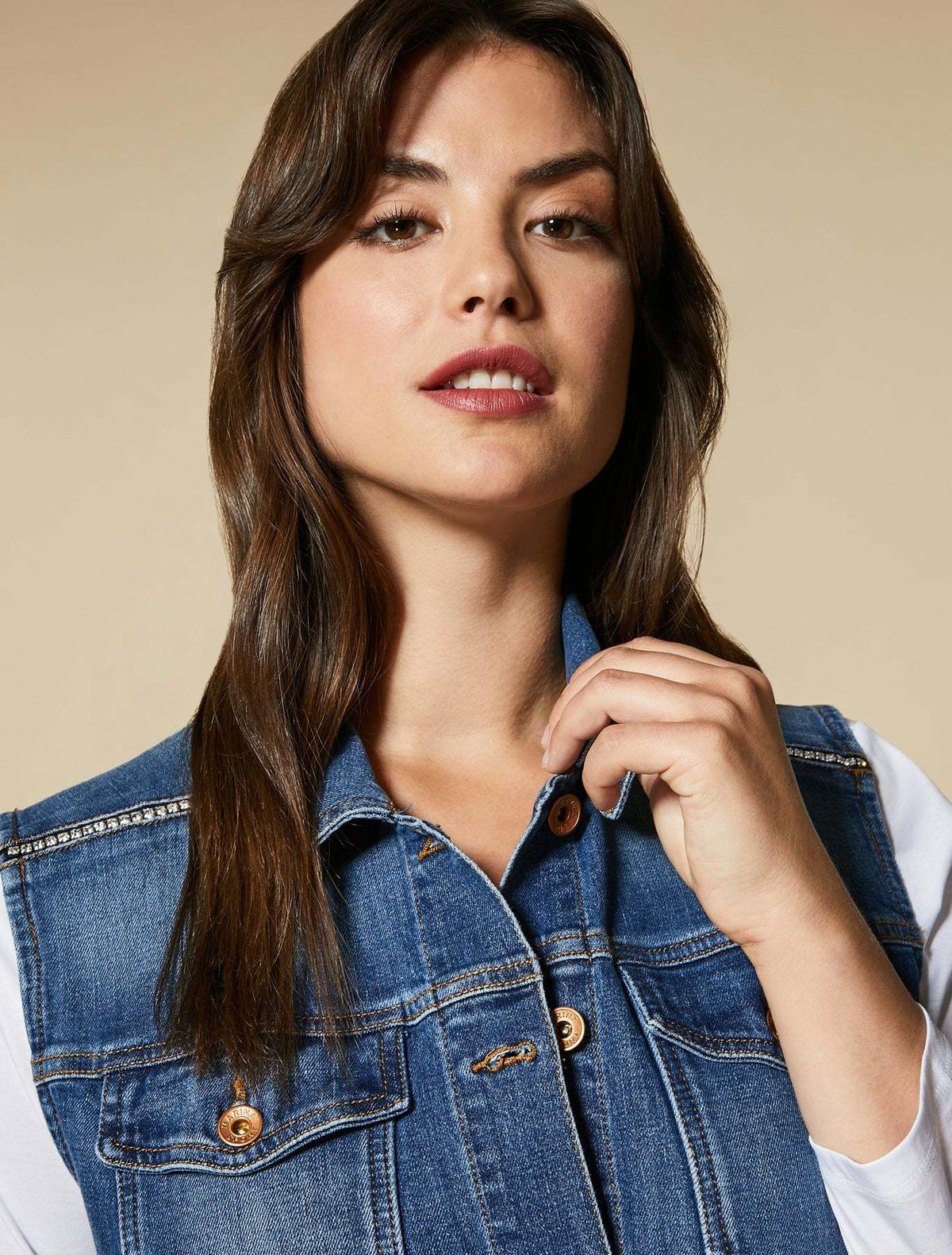 GABBIATE denim vest in blue stretch cotton with rhinestone embellishments on the shoulder and metal button placket