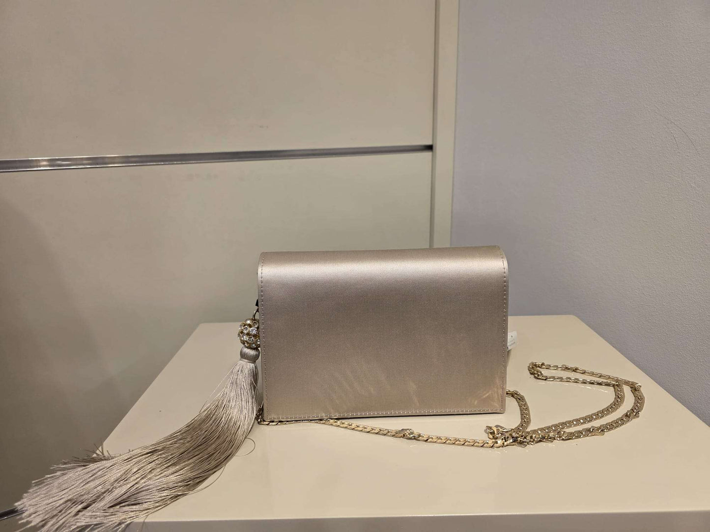 Pearl satin leather bag with rhinestone tassel and gold chain strap by Marina Rinaldi