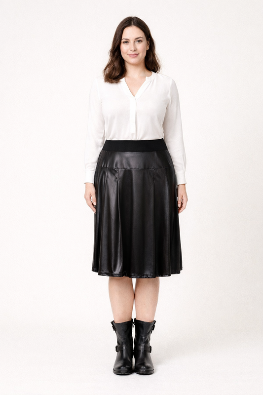 Woman wearing knee-length loose-fit skirt OMBRETTA in faux leather with yoke waist and full lining